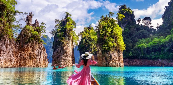 beautiful-girl-standing-boat-looking-mountains-ratchaprapha-dam-khao-sok-national-park-surat-thani-province-thailand-1-2